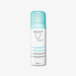 Flacon pulvérisateur blanc de 125 ml de déodorant Vichy Laboratoires Anti-Transpirant avec un bouchon bleu clair, portant un étiquetage bilingue en français et en anglais. Le flacon est placé sur un fond blanc uni. Dakar