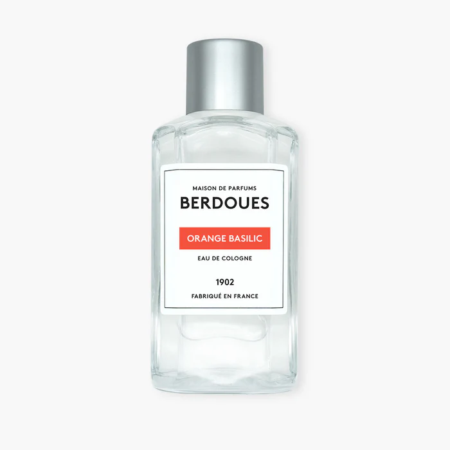 Flacon en verre transparent de l'eau de cologne Berdoues Orange Basilic avec un bouchon argenté et une étiquette blanche avec un texte noir et orange. Dakar