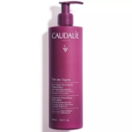 Un grand flacon pompe violet contenant le soin nourrissant hyaluronique « Thé des Vignes » de Caudalie (400 ml) arbore un texte blanc et l'image d'une grappe de raisin sur le devant. Dakar