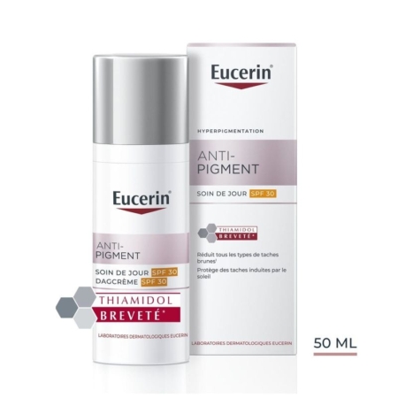 Un flacon et une boîte de 50 ml de Eucerin Anti-Pigment Day Cream SPF 30, qui contient du Thiamidol pour réduire les taches brunes. L'emballage est blanc avec des accents rose clair et gris, et le texte souligne la protection SPF 30. Dakar