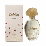 Un flacon de 100 ml d'eau de toilette Cabotine Gold de Grès Paris est posé à côté de son coffret blanc et doré, tous deux ornés de motifs floraux et d'inscriptions dorées. Le flacon est muni d'un bouchon doré en forme de fleur. Dakar