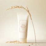 Un tube étiqueté "Medipeel Masque Enveloppant Peel Off Propriétés Lissantes et Raffermissantes Red Lacto Collagen 70 ml" se tient debout sur une surface crème, entouré de grains de riz épars et d'une délicate tige de riz, évoquant une élégance de premier ordre. Dakar