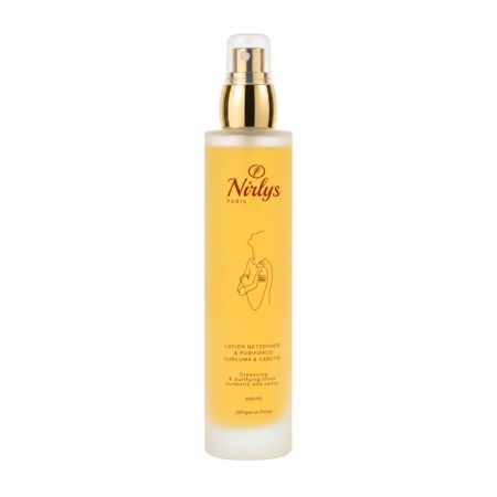 Nirlys Paris Lotion Nettoyante Purifiante Curcuma et Carotte 100 ml se présente dans un flacon en verre givré avec une pompe et un bouchon dorés. L'étiquette comporte un texte orange, un dessin de femme et des informations sur les ingrédients et le volume. Dakar