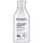 Un flacon blanc de l'après-shampoing « Acidic Bonding Concentrate » de Redken, orné d'une inscription noire et muni d'un bouchon argenté. L'étiquette met en avant la présence d'un complexe de liaison à 11 % et d'acide citrique, et indique un format de 300 ml (10,1 fl oz). Dakar