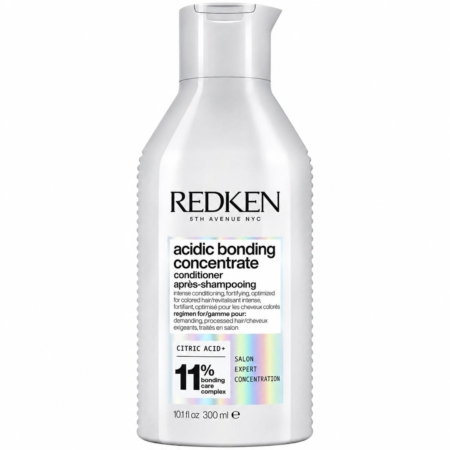 Un flacon blanc de l'après-shampoing « Acidic Bonding Concentrate » de Redken, orné d'une inscription noire et muni d'un bouchon argenté. L'étiquette met en avant la présence d'un complexe de liaison à 11 % et d'acide citrique, et indique un format de 300 ml (10,1 fl oz). Dakar