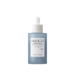 Ce flacon compte-gouttes en verre teinté de bleu, muni d'un bouchon blanc et portant l'étiquette « Skin1004 Hyalu Teca Plumping Ampoule Sérum Peau Rebondie et Lumineuse 50 ml », se distingue par son design minimaliste. Dakar