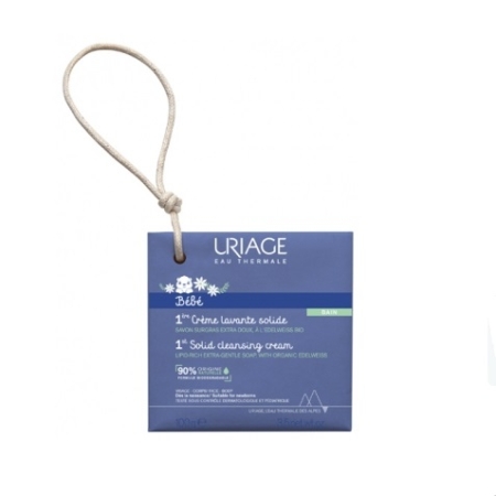 Une boîte bleue d'Uriage Bébé 1ère Crème Lavante Solide 100g avec un cordon de suspension, conçue pour les bébés, avec de l'edelweiss bio et 90% d'ingrédients d'origine naturelle. Dakar