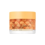 Un pot transparent muni d'un couvercle orange contient la Vt Crème Éclat en Capsules de Vitamine C et d'Astaxanthine Anti-Taches et Anti-Âge 50 ml, rempli de petites capsules orange et muni d'une étiquette indiquant les informations sur le produit. Dakar