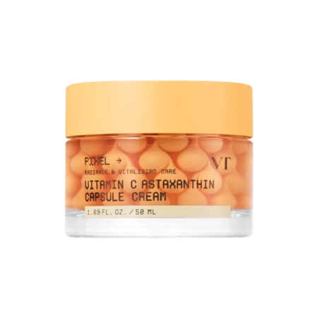 Un pot transparent muni d'un couvercle orange contient la Vt Crème Éclat en Capsules de Vitamine C et d'Astaxanthine Anti-Taches et Anti-Âge 50 ml, rempli de petites capsules orange et muni d'une étiquette indiquant les informations sur le produit. Dakar