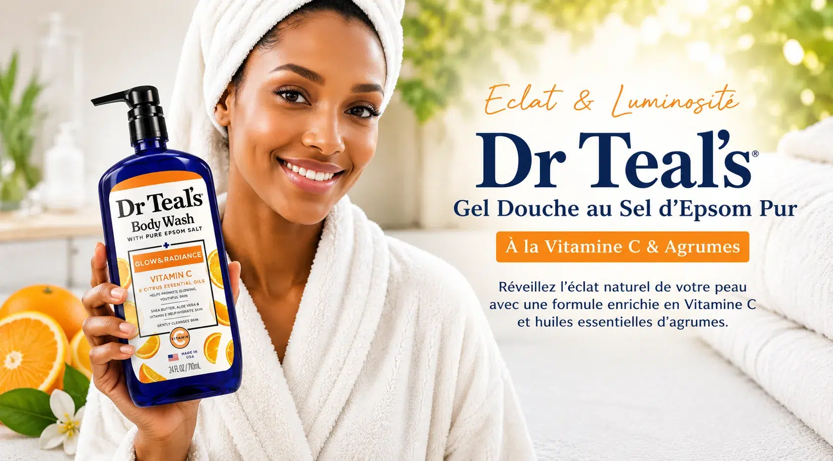 www.universcosmetix.com-brand-dr-teals Une femme souriante en peignoir et serviette blanche tient une bouteille de Dr Teal's Body Wash with Vitamin C & citrus oils d'Univers Cosmetix, à côté d'oranges coupées en tranches. Le texte souligne l'éclat naturel du produit et les bienfaits de la vitamine C. Dakar