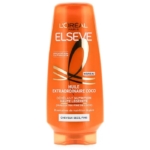 Un flacon orange de l'après-shampoing Elseve Huile Extraordinaire Coco de L'Oréal Paris, destiné aux cheveux secs et fins, avec un texte et des motifs dorés et blancs sur l'étiquette avant. Dakar