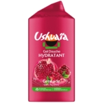 Un flacon rose de gel douche hydratant Ushuaïa, au parfum « Grenade des Açores », avec des illustrations de grenades sur l'étiquette. Dakar